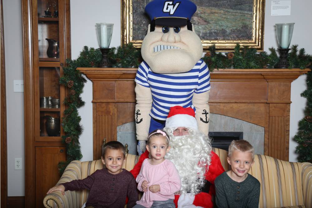 Louie and santa with kids on couch